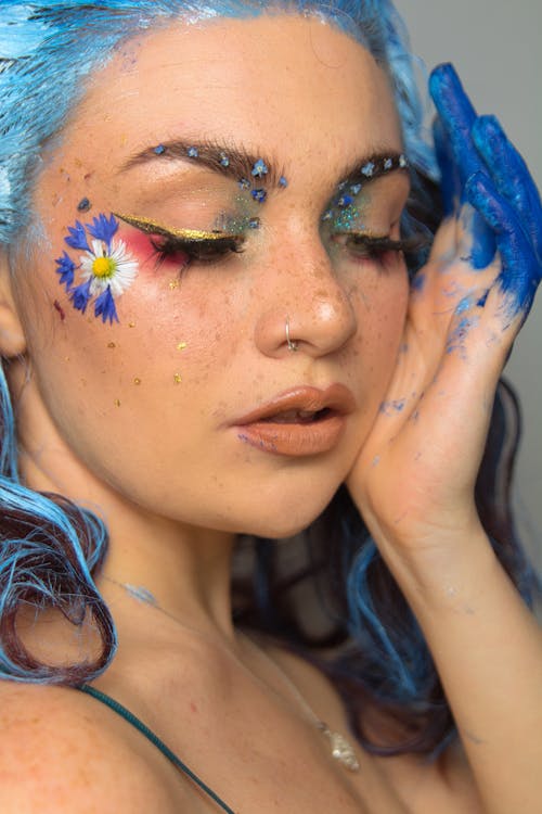 Free Woman with Blue Flower Face Paint Stock Photo