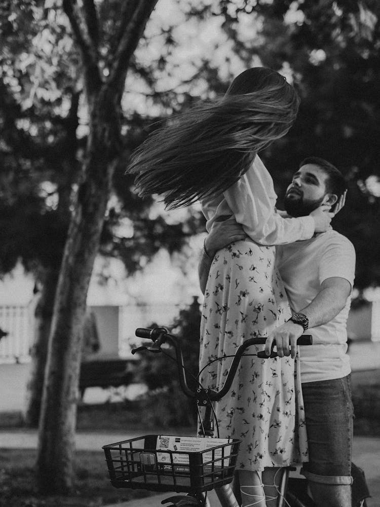 Man And Woman Riding A Bike Together