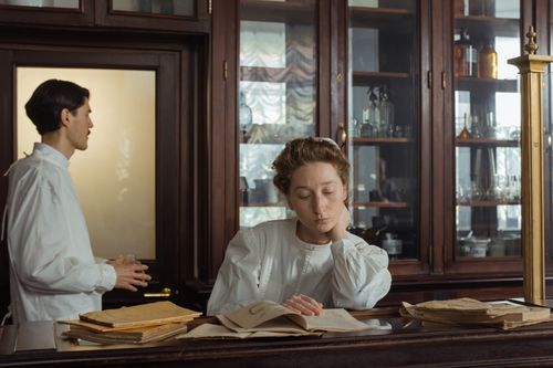 Free A contemplative scene with two scientists in a vintage laboratory setting. Stock Photo