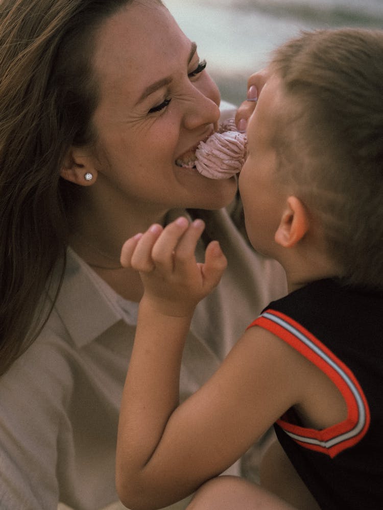 A Mother And Child Sharing Food