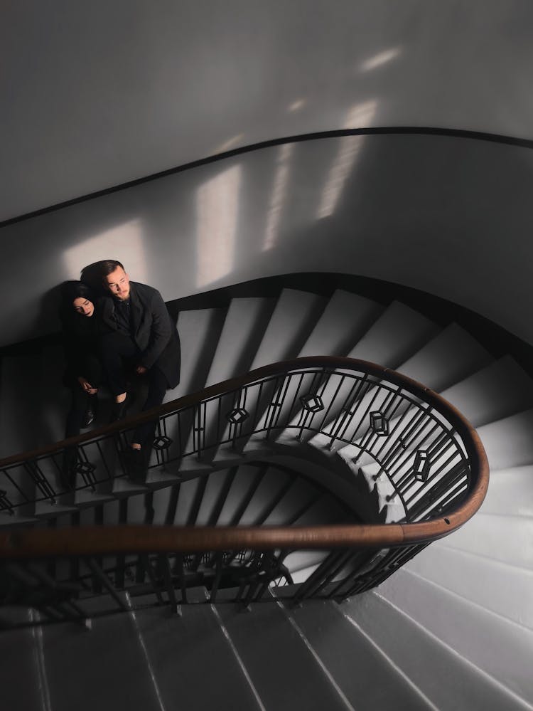 Woman And Man Standing On Stairs