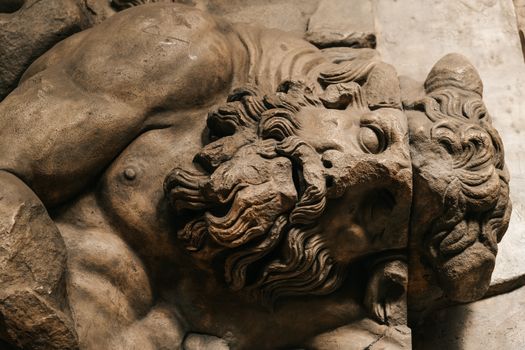 Close-up of a detailed ancient stone sculpture showcasing historic craftsmanship.