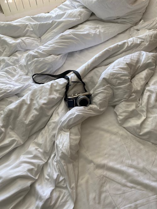 Free A Black Analog Camera on a White Blanket Stock Photo