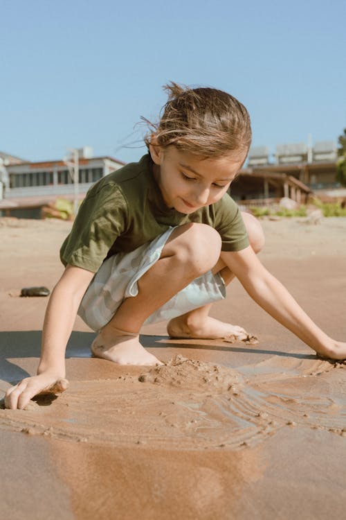 A Kid Playing Sand at the Beach