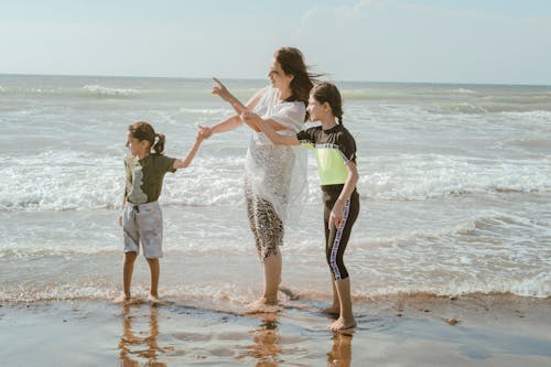 A Woman at the Beach With Her Kids