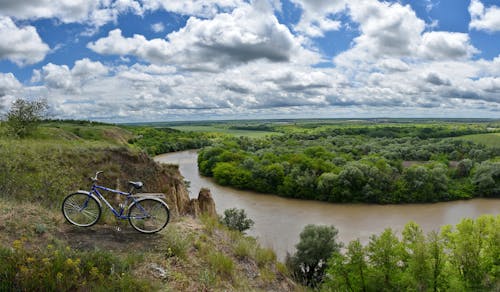 Free Bicycle Parked on a Cliff of Riverbank Stock Photo