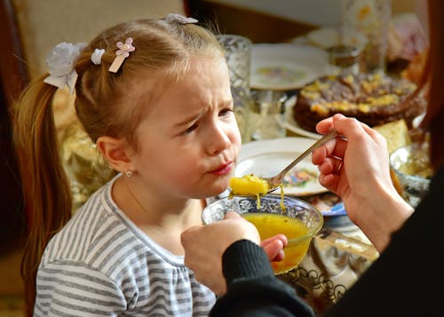 Free Person Feeding a Young Girl Stock Photo