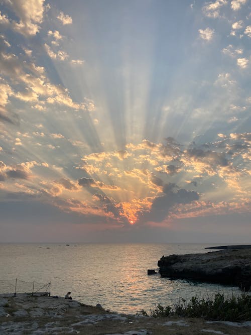 Free View of Sunset Over the Horizon with Rays of Light Stock Photo