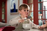 Boy in White Sweater Holding Silver Spoon