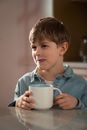 Boy in Gray Hoodie Holding White Ceramic Mug