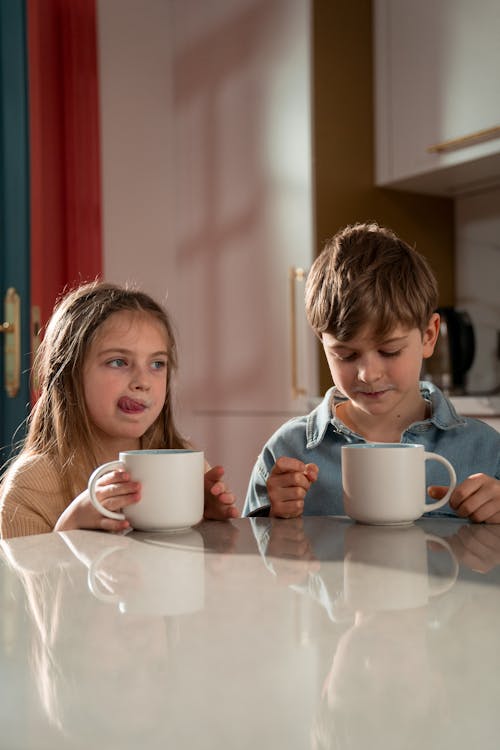 Free Boy and Girl Having Their Breakfast Stock Photo
