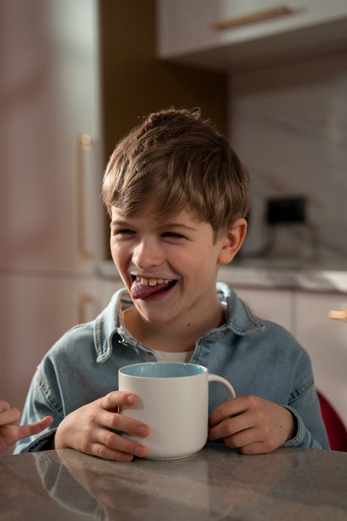 Free A Boy Sitting at the Table Stock Photo