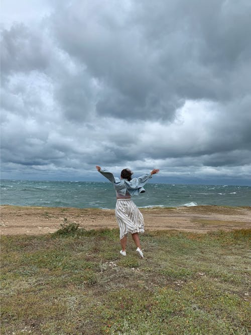Woman Wearing Denim Jacket Standing Near Seashore
