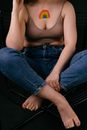 Woman in Blue Denim Jeans Sitting on Black Chair