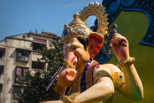 Free Colorful Ganesha statue displayed during a Mumbai street festival, showcasing Hindu culture and tradition. Stock Photo