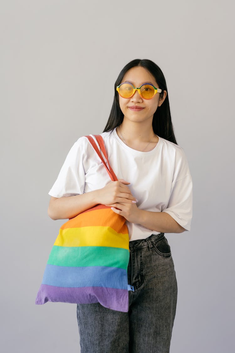 A Woman Holding A Rainbow Tote Bag