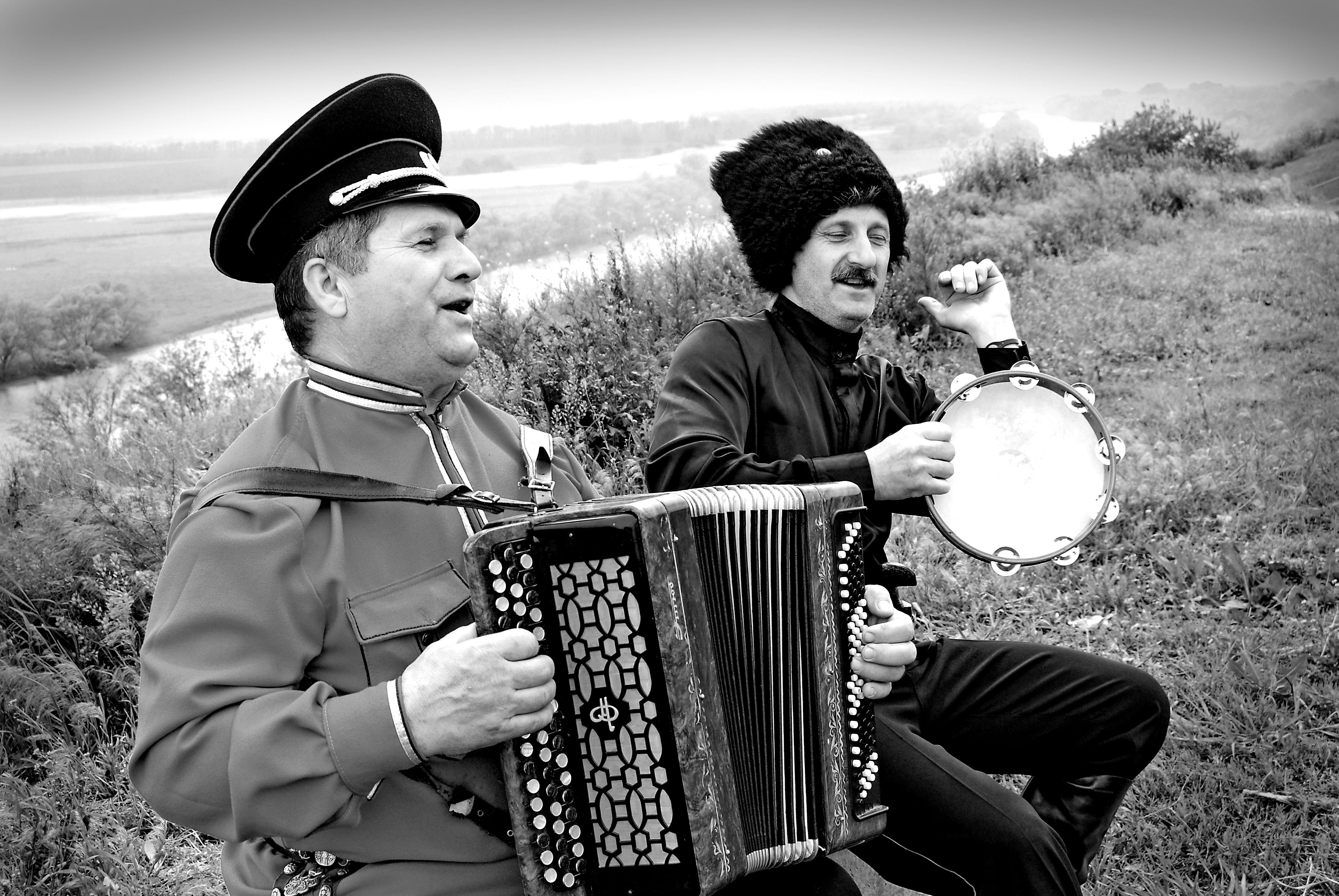 Men Playing on Accordion and Tambourine and Singing · Free Stock Photo