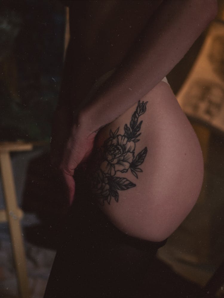 Closeup Of Female Body With Rose Tattoo