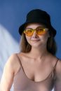 Woman in Black Tank Top Wearing Blue Sunglasses