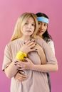 Woman in Pink Long Sleeve Shirt Holding Yellow and Blue Plastic Bottle