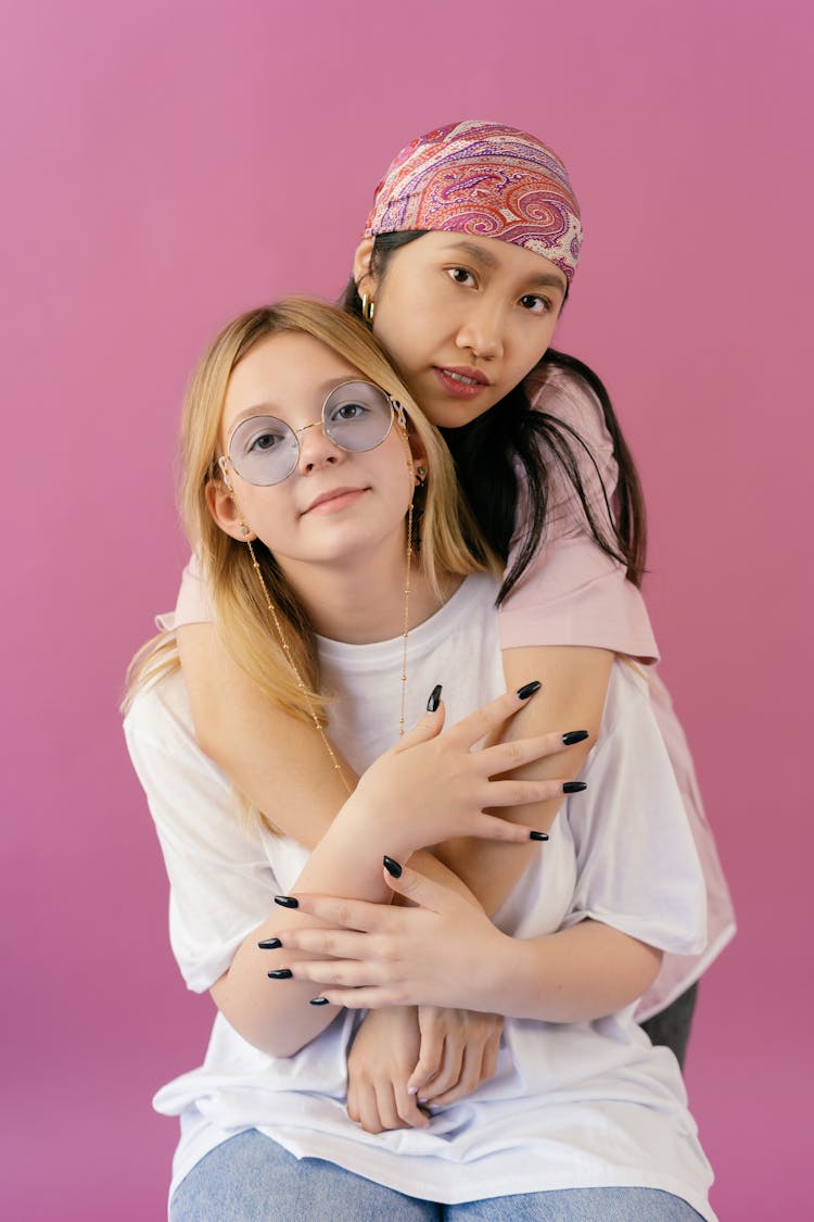 A Girl Hugging Her Friend With Sunglasses