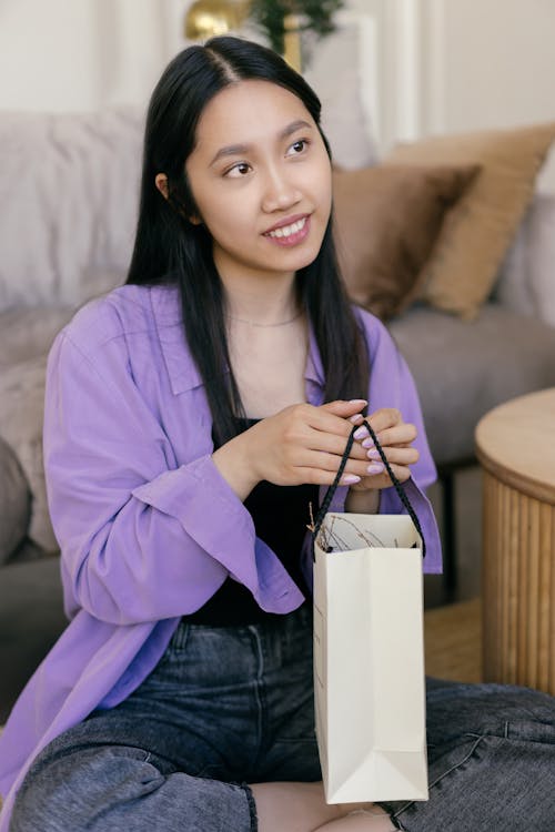 Woman in Purple Shirt Holding a Shopping Bag