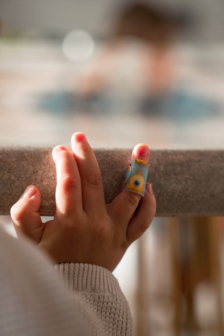 Close-Up Photo Of Baby's Hand With Bandage
