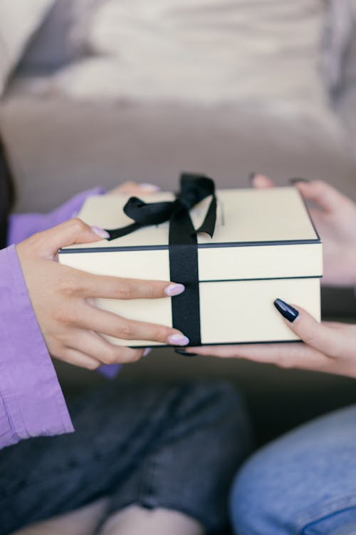 Free Close-Up Shot of Two People Holding a Gift Stock Photo