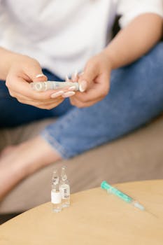 Close-up of hands holding insulin syringe, indicating healthcare routine.