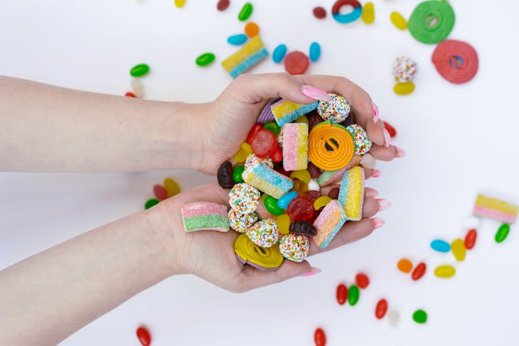 Close-Up Shot Of A Person Holding Assorted Candies