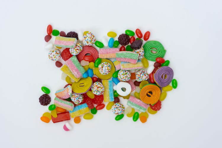 Close-Up Shot Of Assorted Candies On A White Surface