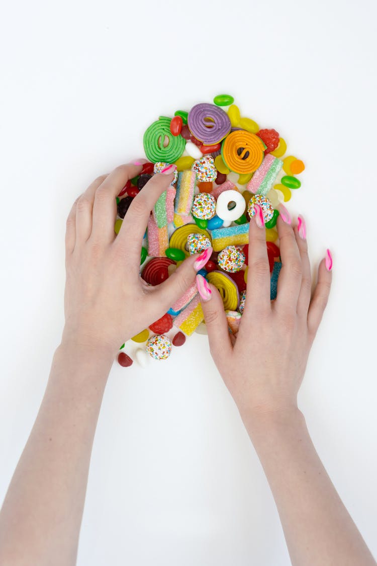 Close-Up Shot Of A Person Holding Assorted Candies