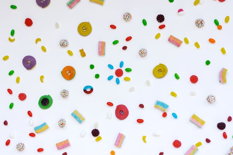 Close-Up Shot Of Assorted Candies On A White Surface