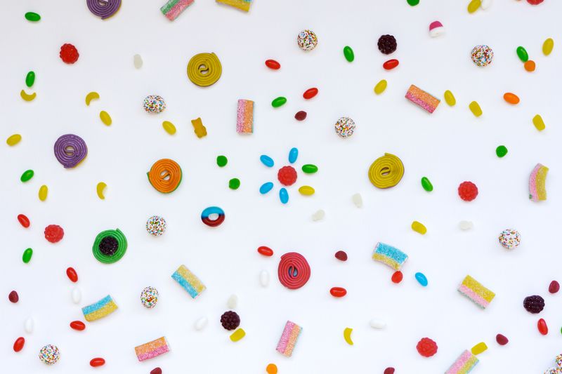 Close up shot of assorted hard candies on a white surface