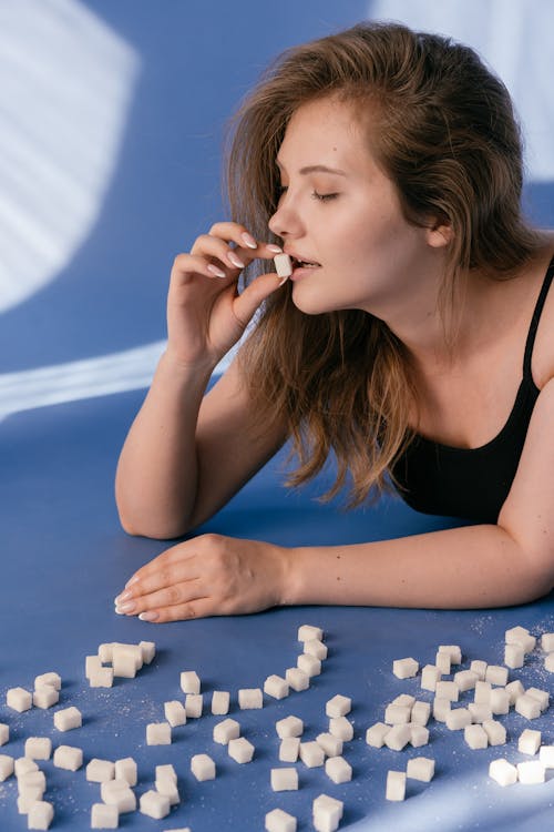 A Woman Eating a Sugar Cube