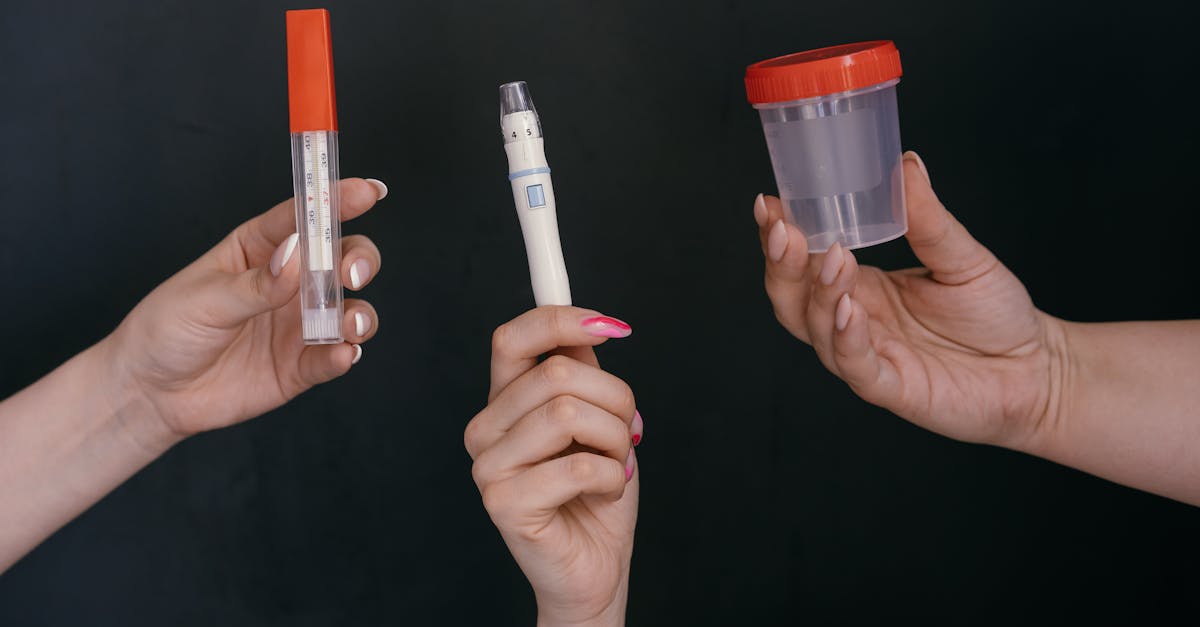 People Holding Medical Devices and a Urine Collector for Glucose Checking