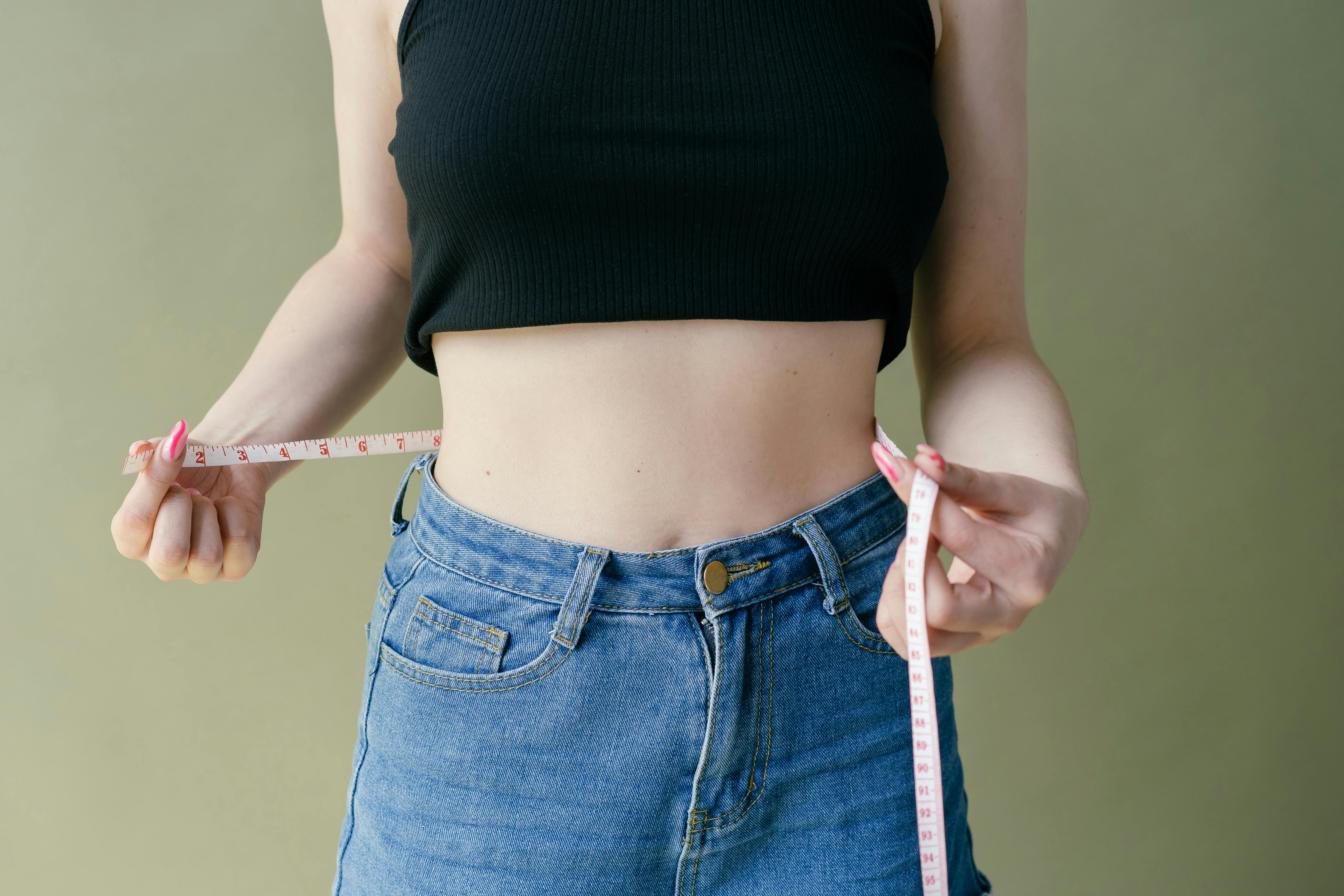 Close Up Photo of Model Girl Measure Her Waist with Measuring Tape in Blue  Pants Close Up Photo Stock Image - Image of health, fasting: 169212791