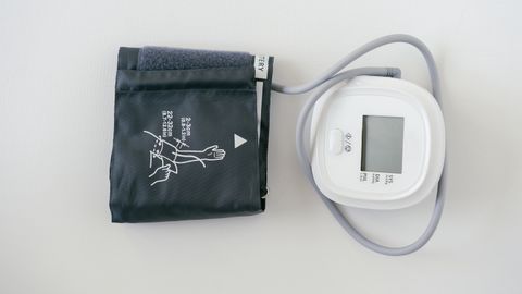 A digital sphygmomanometer on a white background, used for measuring blood pressure.