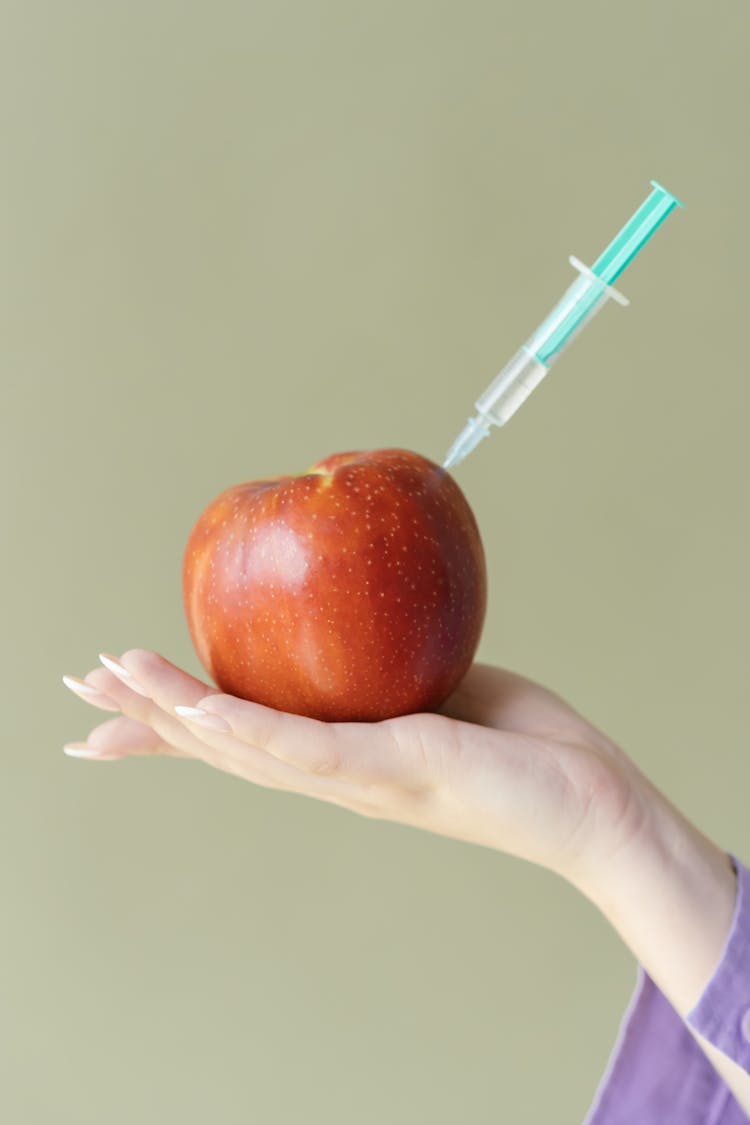 Photo Of An Apple With A Syringe