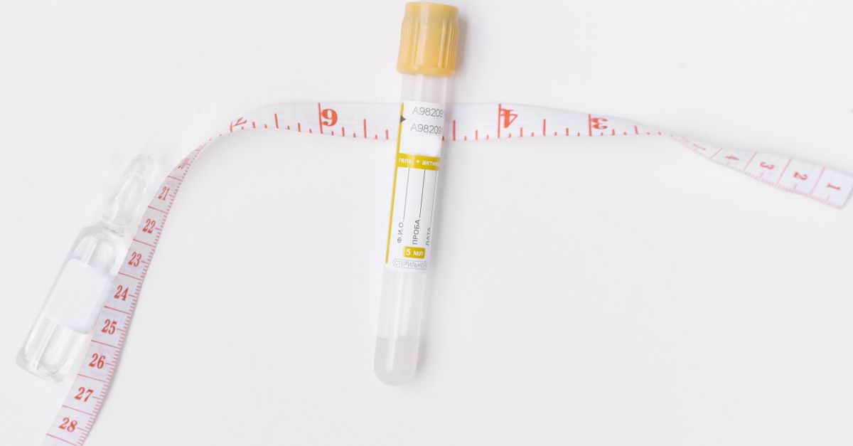 Image of an empty test tube and a measuring tape on a white background, ideal for healthcare and laboratory themes. - Evidence evidence guide for fiber satiety randomized trial