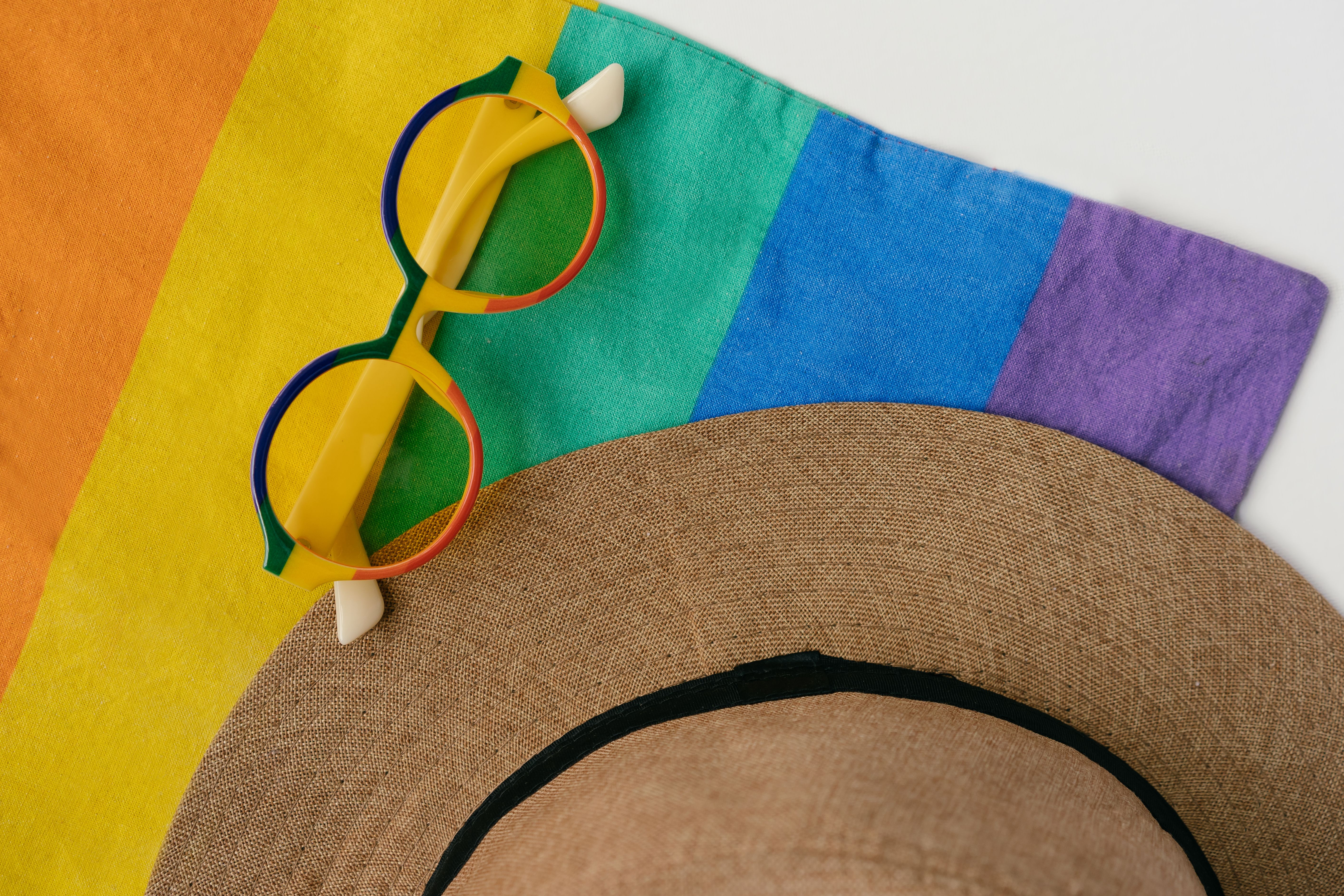 Flat-lay of colorful Pride accessories, apparel, and body-safe wellness products