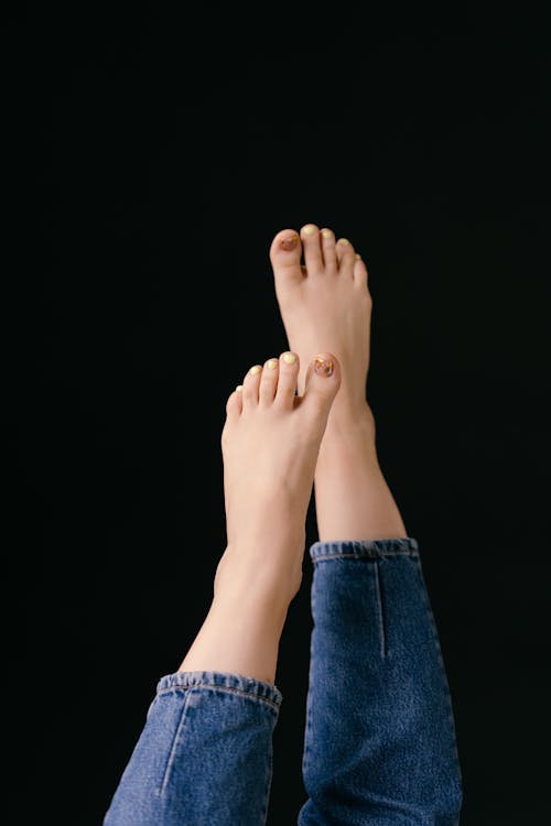 Beautiful Feet of a Person Wearing Denim Jeans