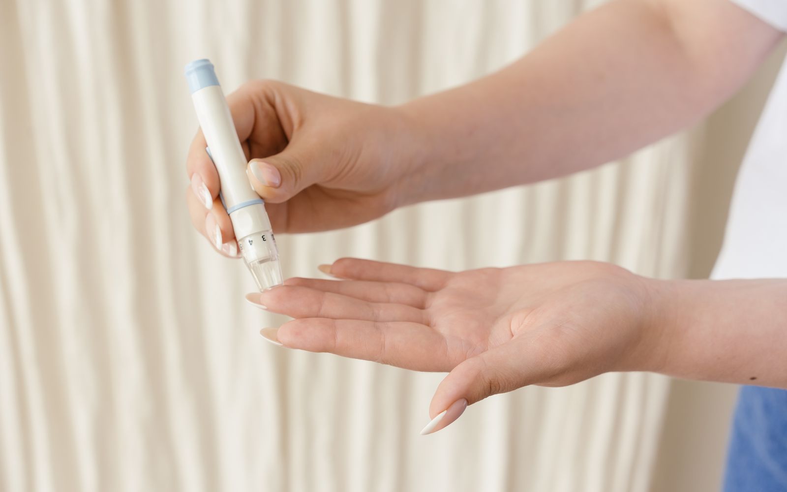 Close-up of hands using a glucometer to check blood sugar
