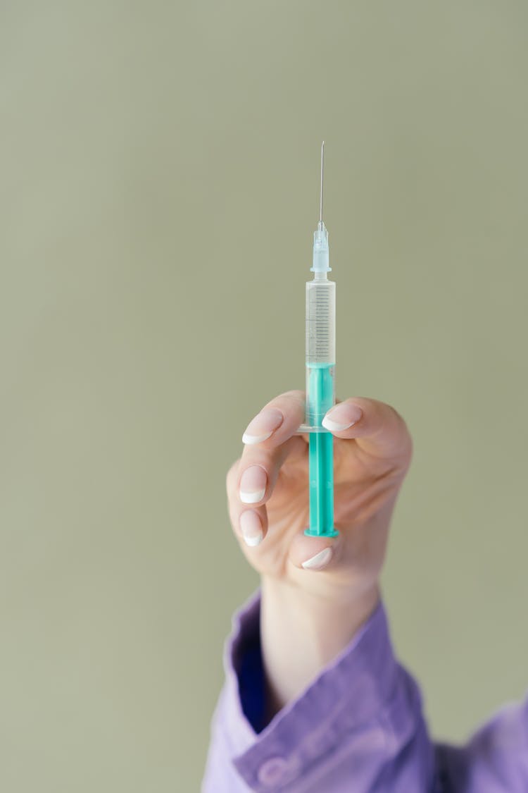 Person Holding A Syringe 
