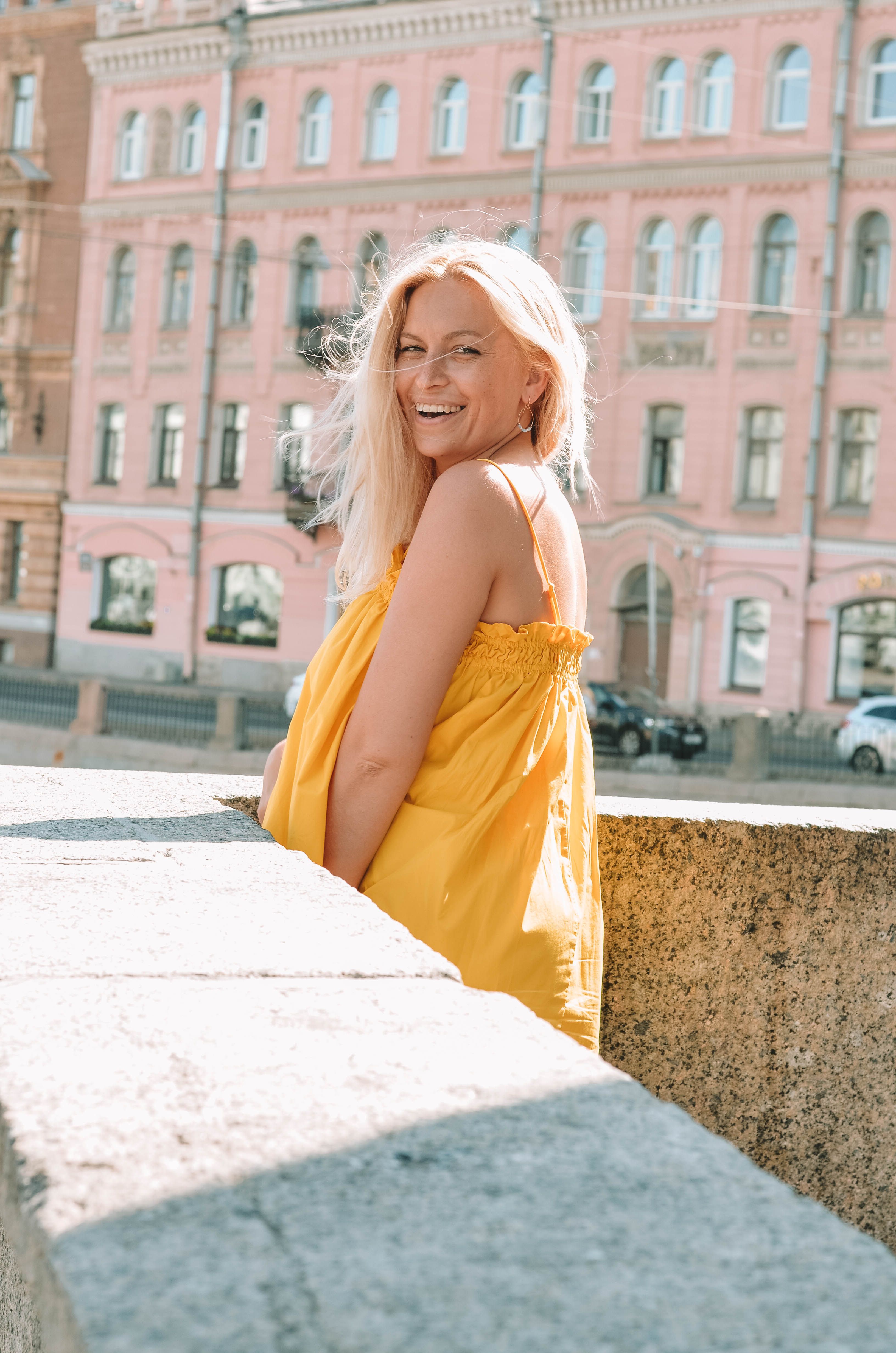Blonde Woman in Yellow Dress on Concrete Railing · Free Stock Photo