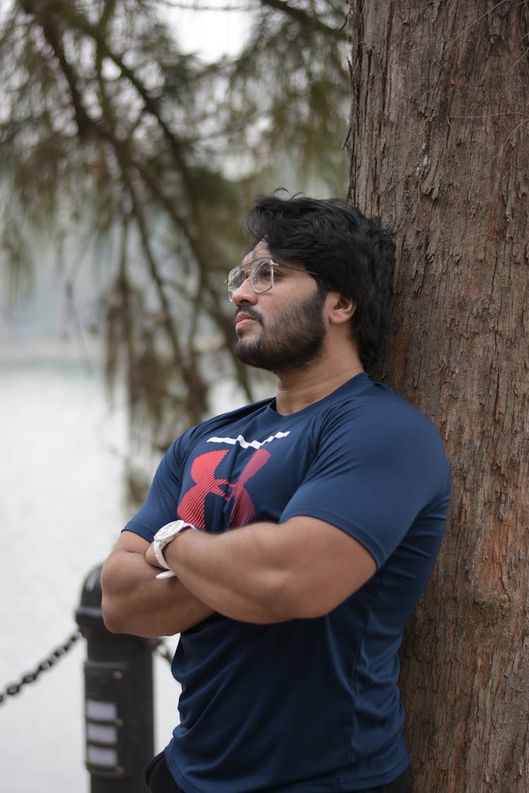 Bearded Man Leaning Against The Tree