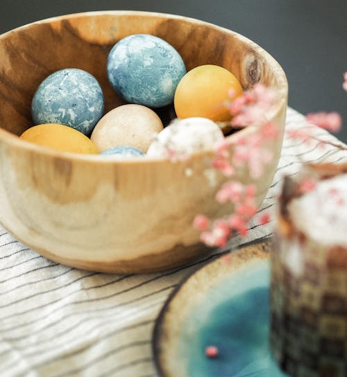 Colored Eggs in a Wooden Bowl