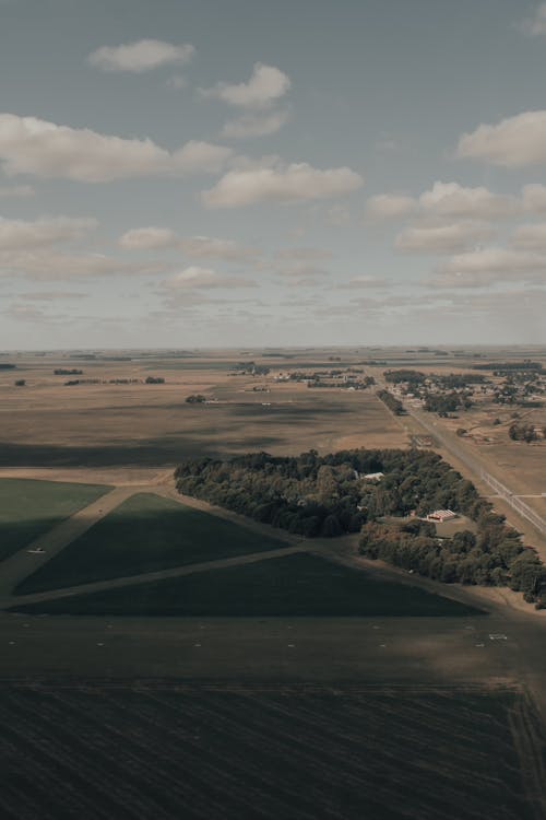 Aerial Photography of Grass Field Under White Clouds