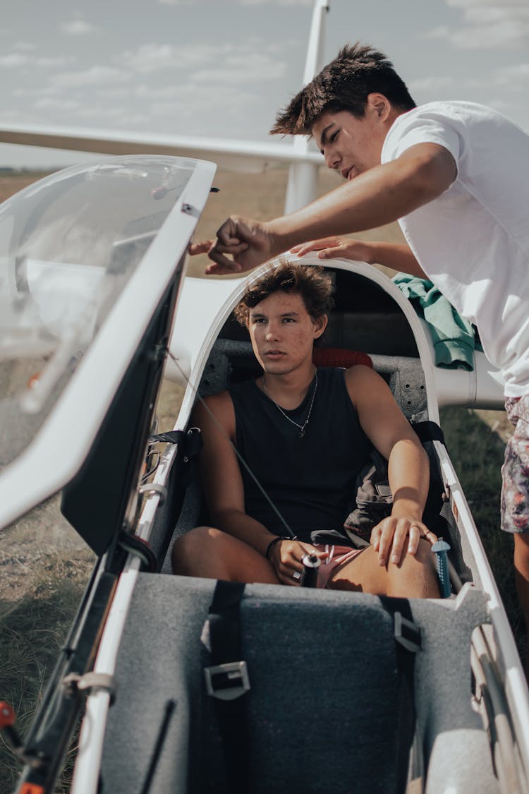 Men Talking In Small Plane On Beach