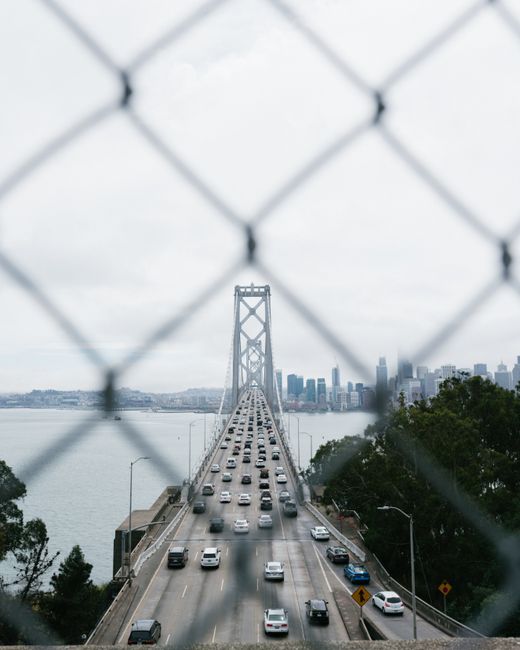 Aerial view of San Francisco's Bay Bridge with skyline in the background.